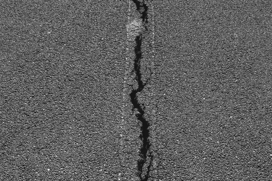 Long crack running through an asphalt surface